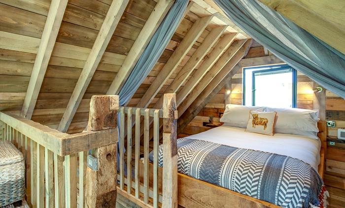 King size bed on the mezzanine floor at Cadwollen'